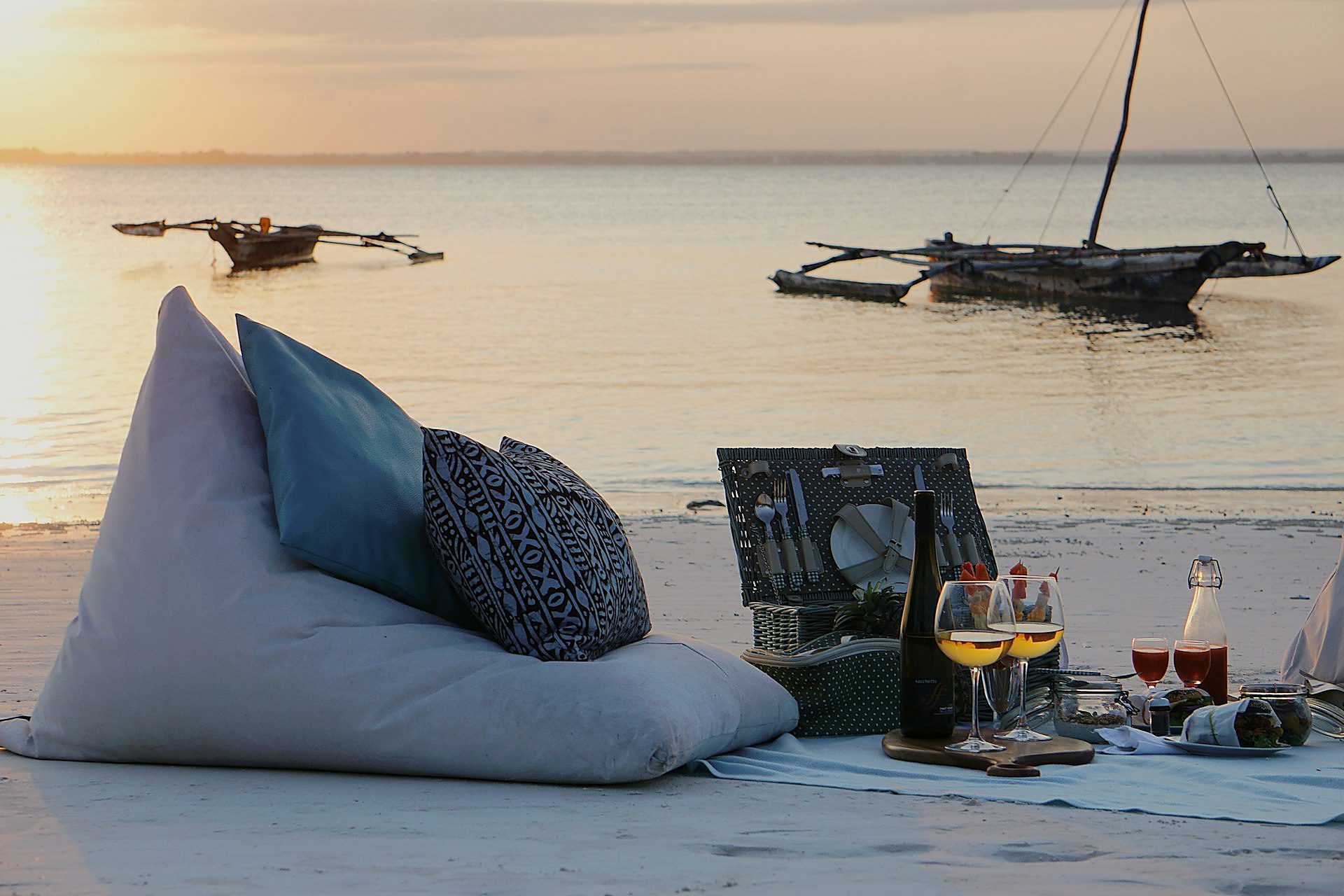 Beach bar tables on the sand at sunset, Paje